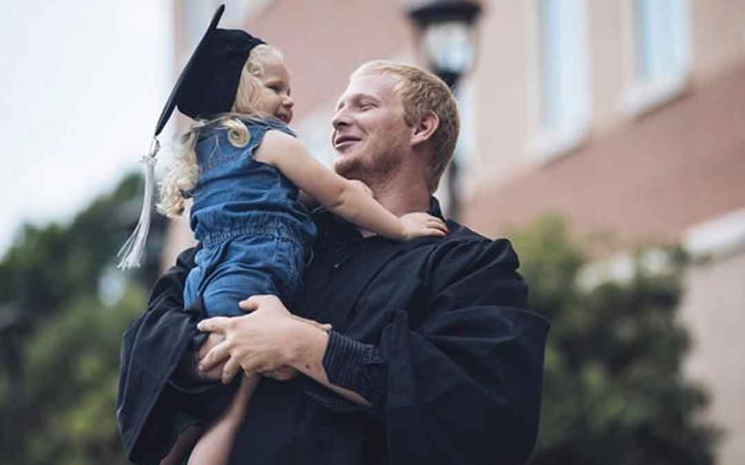 Graduate holding daughter